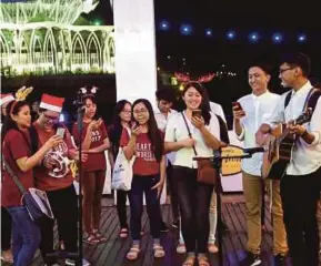  ?? BERNAMA PIC ?? Carollers singing Christmas tunes near the Kuching Waterfront yesterday.