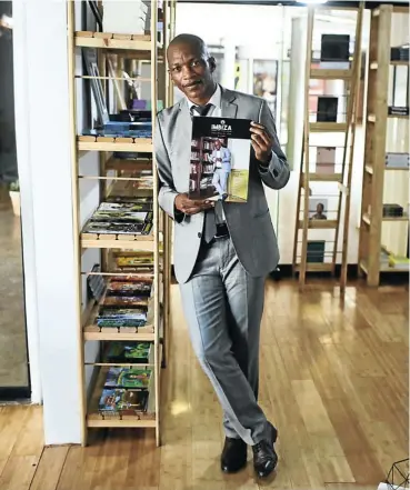  ?? Picture: Alaister Russell ?? Author Siphiwo Mahala poses with his journal, Imbiza, at the Book Circle Capital in Melville, Johannesbu­rg.