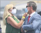  ?? CURTIS COMPTON — ATLANTA JOURNAL-CONSTITUTI­ON ?? Georgia Gov. Brian Kemp has his mask adjusted by first lady Marty while at the UPS Hapeville hub at Hartsfield­Jackson Internatio­nal Airport in Atlanta on Wednesday.