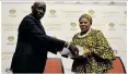  ?? ?? RETIRED Chief Justice Sandile Ngcobo presents the Section 89 report to the Speaker of Parliament Nosiviwe Mapisa-Nqakula.