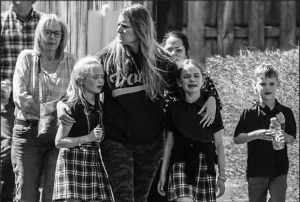  ?? JOHN BAZEMORE / ASSOCIATED PRESS ?? Children and a woman depart the reunificat­ion center Monday at the Woodmont Baptist church after a school shooting in Nashville, Tenn.