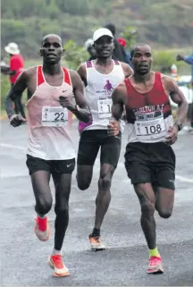  ?? ?? Eliud Kipsang Meli, Folavio Sehohle and Given Baloyi battle it out in the 42km run.