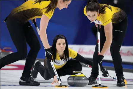  ?? The Canadian Press ?? Team Manitoba skip Kerri Einarson releases a rock to lead Briane Meilleur and second Shannon Birchard during the Scotties Tournament of Hearts in Moose Jaw, Sask., on Feb. 22, 2020.