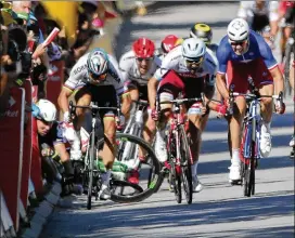  ?? AP ?? Mark Cavendish (left, on ground) crashes after trying to squeeze by Peter Sagan (left rider) late in Tuesday’s fourth stage. Cavendish suffered a fractured right scapula.