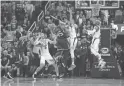  ??  ?? The Suns’ Devin Booker fouls the Jazz’s Donovan Mitchell, who made the winning free throw in the final second on Monday.