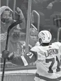  ?? ALEX
BRANDON/AP ?? Red Wings center Dylan Larkin, bottom, celebrates his game-winning goal in overtime against the Capitals Wednesday in Washington.