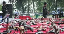  ?? REN YONG / FOR CHINA DAILY ?? Illegal firearms seized by police since 2018 are displayed before being destroyed in Wuhan, Hubei province, on Monday.