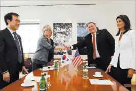  ?? Richard Drew ?? The Associated Press South Korean Foreign Minister Kang Kyung-wha shakes hands Friday with Secretary of State Mike Pompeo in South Korea’s mission in New York. Joining them are South Korean U.N. ambassador Cho Tae-yul, left, and U.S. ambassador to the U.N. Nikki Haley.