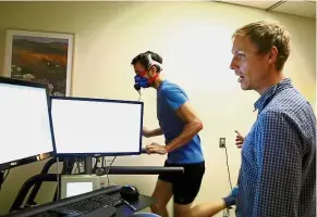  ??  ?? Dr Mattsson monitors the workout of Davis. Mattsson uses the treadmill test to identify athletes with freakishly high VO2 max scores, which indicate superior cardiovasc­ular function.