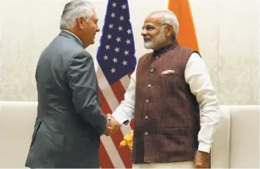  ?? Alex Brandon / Associated Press ?? Rex Tillerson (left) greets Indian Prime Minister Narendra Modi at their meeting in New Delhi.