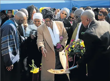  ?? Picture: WERNER HILLS ?? SAD FAREWELL: Welekazi Nkohla pays her last respects to her twin brother, rugby legend Welile ‘Bomza’ Nkohla, at the Papenkuil Cemetery in Gelvandale yesterday