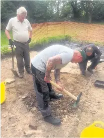  ?? Military veterans hard at work as part of an archaeolog­ical dig on the site of the 18th century mansion, Lathom House, itself built on the same site as a medieval fortress known as Lathom Castle, left ??