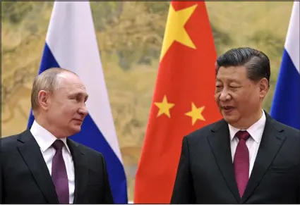  ?? ALEXEI DRUZHININ — SPUTNIK, KREMLIN POOL VIA AP FILE ?? Chinese President Xi Jinping, right, and Russian President Vladimir Putin talk to each other during their meeting in Beijing, China, on Feb. 4, 2022.