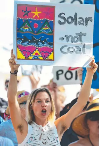 ?? STRONG MESSAGE: An anti- Adani protester at a rally on The Strand last year. ??