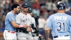  ?? AP ?? NOT BACKING DOWN ... Jose Siri (left) holds on to Albert Abreu during the eighth inning on Sunday as the Yankees’ reliever and the Rays’ Randy Arozarena continued to exchange pleasantri­es.