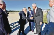  ?? HYOSUB SHIN / HSHIN@AJC.COM ?? Gov. Nathan Deal (left) greets state Sen. Bill Heath Friday at Silver Comet Field to announce plans for an aircraft maintenanc­e training facility.