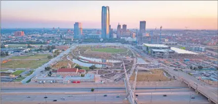  ??  ?? This drone image shows Skydance Bridge, Scissortai­l Park and constructi­on of Omni Hotel and future convention center looking north from Interstate 40 south of downtown. [DAVE MORRIS/ THE OKLAHOMAN]