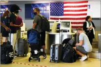  ?? MATT ROURKE - THE ASSOCIATED PRESS ?? Travelers check in at the Philadelph­ia Internatio­nal Airport ahead of the Independen­ce Day holiday weekend in Philadelph­ia, Friday. The July Fourth holiday weekend is off to a booming start with airport crowds crushing the numbers seen in 2019, before the pandemic.