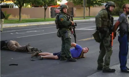  ?? Photograph: Adolphe Pierre-Louis/Albuquerqu­e Journal/ZUMA/REX/Shuttersto­ck ?? Steven Baca, center, taken into custody after he shot and wounded a man as the crowd tried to take down statue in Albuquerqu­e, on 15 June.