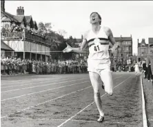  ?? Associated Press 1954 ?? Roger Bannister becomes the first athlete to run a mile in less than four minutes at the University of Oxford on May 6, 1954.