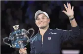  ?? ANDY BROWNBILL — THE ASSOCIATED PRESS ?? Ash Barty of Australia waves as she holds the Daphne Akhurst Memorial Cup after defeating Danielle Collins of the U.S., in the women’s singles final at the Australian Open tennis championsh­ips in Saturday in Melbourne, Australia.