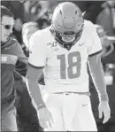  ?? CHARLIE NEIBERGALL/AP ?? Illinois quarterbac­k Brandon Peters is helped off the field after suffering an injury late in the game against Iowa on Saturday.