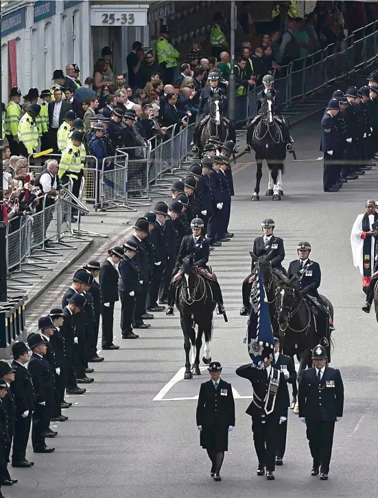  ??  ?? A show of respect and gratitude: Thousands of police officers and members of the public line the streets of London yesterday as PC Keith Palmer’s funeral procession makes its way from Westminste­r to Southwark Cathedral