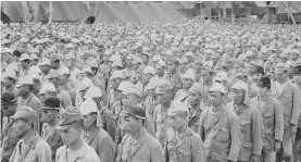  ??  ?? In this 5 September 1945, file photo, part of 2,600 Japanese POWs, who comprised the enemy garrison on the island of Rota, are lined up in a prisoner of war stockade on Guam, in the Marianas Islands. They were brought from their island holdout 50 miles away.