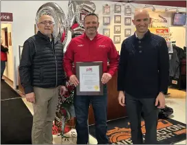  ?? LARISSA BERISWILL — THE MORNING JOURNAL ?? Mayor Hans Schneider, left, Tom Stannard and Jonathan Greever, Wellington Village Director with the plaque declaring Feb. 20, 2024, as Wellington Implement Day.