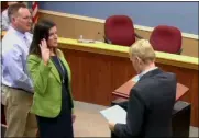  ?? COURTESY OF AVON LAKE COMMUNITY TELEVISION ?? New Ward 1 councilwom­an Billie Jo David, center, is sworn in by Law Director Gary Ebert on March 16.