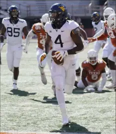  ?? Associated Press ?? West Virginia’s Leddie Brown runs into the end zone to score a touchdown in a Nov. 7 game last season against Texas in Austin, Texas.