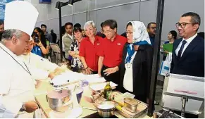  ??  ?? Food for thought: KDU’s Adrian Pinto (left), 55, serving nitrogen ice cream to Higher Education director-general Datin Paduka Dr Siti Hamisah Tapsir (second from right) as Star Media Group Bhd chief operating officer Datuk Calvin Kan (third from...