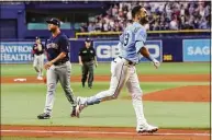  ?? Mike Carlson / Getty Images ?? The Rays’ Kevin Kiermaier, right, celebrates his game-winning home run in front of Red Sox pitcher Hansel Robles during the 10th inning on Saturday.
