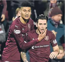  ??  ?? Hearts’ Bjorn Johnsen (left) congratula­tes Jamie Walker on sealing the win against Motherwell.