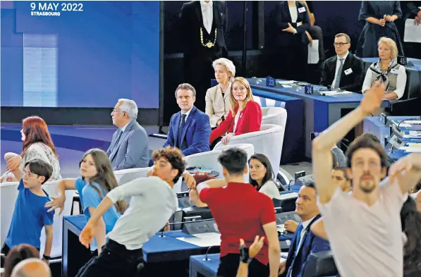  ?? ?? Emmanuel Macron, above centre, watches the nine-minute performanc­e at the European Parliament yesterday. The youngsters were told to ‘use your hands like fish’ in an interpreta­tive dance to celebrate the future of Europe