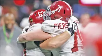  ?? STAFF PHOTO BY C.B. SCHMELTER ?? Alabama offensive linemen J.C. Hassenauer, left, and Ross Pierschbac­her celebrate after the Crimson Tide beat Georgia 26-23 in overtime in the College Football Playoff final for the 2017 season at Atlanta’s Mercedes-Benz Stadium.