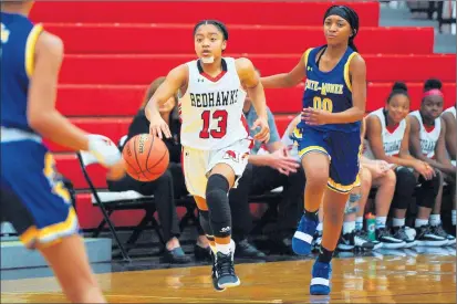  ?? GARY MIDDENDORF/DAILY SOUTHTOWN ?? With a bandage covering six stitches on her chin, Marist’s Kira Chivers works the ball up the court against Crete-Monee during a game on Nov. 20, 2019.