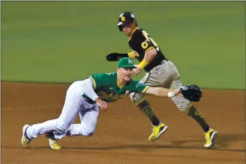  ?? DOUG DURAN — BAY AREA NEWS GROUP, FILE ?? The Padres’ Jake Cronenwort­h (9) runs to third base as A’s third baseman Matt Chapman (26) dives for a batted ball before making the throw to first base during the sixth inning of their Sept. 4 game at the Coliseum in Oakland.