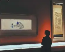  ?? PHOTOS BY JIANG DONG / CHINA DAILY ?? From left: A visitor examines ancestors’ portraits of Li Wenzhong’s family at the Legacy From the Prince of Qiyang, a long-term exhibition at the National Museum of China that traces the ups and downs of the Li family from the Ming Dynasty (1368-1644). More than 70 objects are on show, including Chinese paintings.