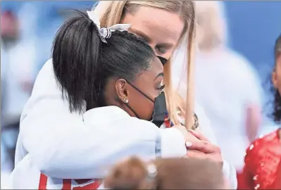  ?? Wally Skalij/Los Angeles Times ?? USA’s Simone Biles is consoled after competing on the vault and withdrawin­g from competitio­n due to an injury in the women’s team final at the 2020 Tokyo Olympics on Monday in Tokyo.