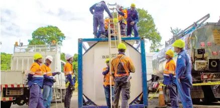  ??  ?? Fulton Hogan Hiway staff and Safety Trainers Ready to scale the heights – practicing the use of a safety harness.