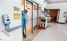  ?? Nathan Papes / Associated Press ?? A nurse looks out from a COVID patient’s room on July 16 in the CoxHealth Emergency Department in Springfiel­d, Mo.