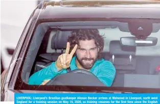  ?? —AFP ?? LIVERPOOL: Liverpool’s Brazilian goalkeeper Alisson Becker arrives at Melwood in Liverpool, north west England for a training session on May 19, 2020, as training resumes for the first time since the English Premier League was halted due to the COVID-19 pandemic.