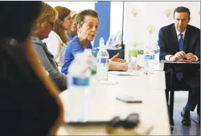  ?? Erik Trautmann / Hearst Connecticu­t Media ?? U.S. Sen. Chris Murphy, D-Conn., holds a roundtable discussion on Thursday with U.S. Rep. Jim Himes, D-Conn., Community Health Center CEO Maria Escalera and people with preexistin­g conditions at the Norwalk Community Health Care System in Norwalk.