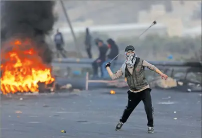  ?? AP PHOTO ?? Palestinia­ns clash with Israeli troops following a protest against U.S. President Donald Trump’s decision to recognize Jerusalem as the capital of Israel, in the West Bank City of Nablus Sunday.