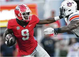  ?? JOHN BAZEMORE / ASSOCIATED PRESS ?? Georgia wide receiver Jackson Meeks (9) tries to fight off Auburn linebacker Owen Pappoe (0) after a catch during the second half of their 42-10 win on Saturday against the TIgers in Athens, Ga.