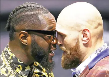  ?? VICTOR DECOLONGON/GETTY IMAGES/AFP ?? Deontay Wilder (left) and Tyson Fury butt heads onstage during a press conference in Los Angeles on October 3. The pair nearly came to blows that day and they engaged in an angry face-off on Wednesday.