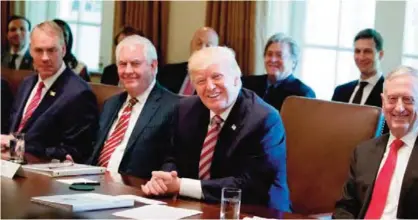  ??  ?? WASHINGTON: President Donald Trump, accompanie­d by, from left, Interior Secretary Ryan Zinke, Secretary of State Rex Tillerson Defense Secretary Jim Mattis, smile during a Cabinet meeting, Monday, June 12, 2017, in the Cabinet Room of the White House....