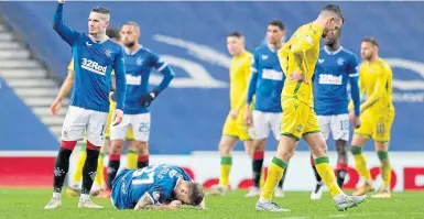  ??  ?? Rangers substitute Scott Arfield lies stricken with an ankle knock