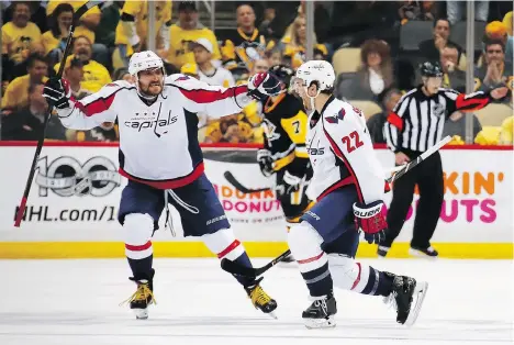  ?? GREGORY SHAMUS/GETTY IMAGES ?? Washington Capitals defenceman Kevin Shattenkir­k, right, celebrates with captain Alex Ovechkin, left, after scoring an overtime goal to beat the Pittsburgh Penguins 3-2 in Game 3 on Monday in Pittsburgh. The Penguins lead the series 2-1.